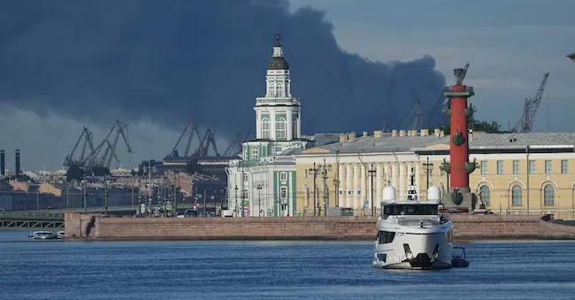 Wednesday, June 3, 2026, a column of black smoke rises above the port of St. Petersburg, Russia, following a Ukrainian drone attack. (AP Photo) APN