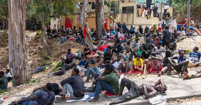 Some migrants rest outside the Temporary Center for Immigrants (CETI) after crossing the border from Morocco to the Spanish enclave of Ceuta, Friday, July 31, 2026. CETI is the Spanish acronym for migrant reception center. (AP Photo/Antonio Sempere)  Associate Press/ LaPresse
Only Italy and Spain APN