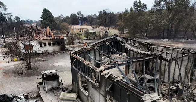 A drone view shows a burnt building in an area affected by wildfire, in Le Porge, Gironde, amongst worsening drought conditions following a heatwave and water shortages across much of France, July 26, 2026. REUTERS/Manon Cruz REUTERS