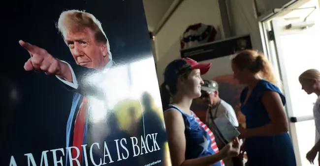 Visitors are welcomed by a poster depicting United States President Donald Trump at the United States Department of Agriculture (USDA) booth at the Great American State Fair, celebrating the 250th anniversary of United States independence in Washington, D.C., United States, July 2, 2026. REUTERS/Jonathan Ernst REUTERS