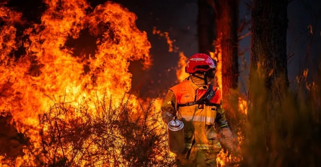 A firefighter engaged in containing a severe forest fire near Saumos, in the Gironde department, France, on July 29, 2026, EPA/MAEL DUBIEZ