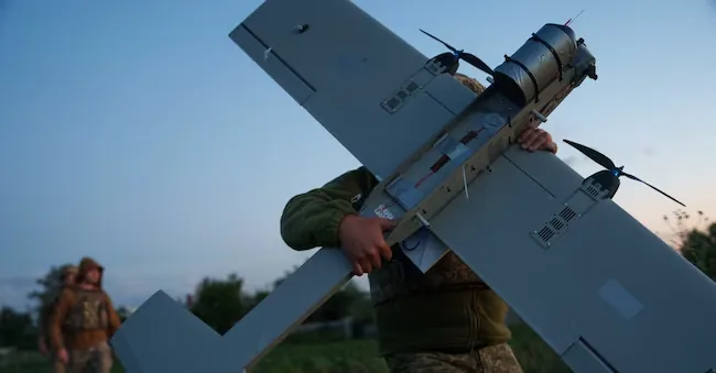 A Ukrainian soldier from the K-2 brigade carries a medium-range APN drone