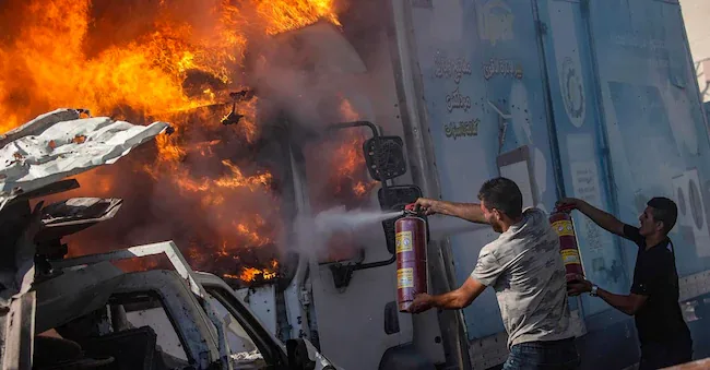 Palestinians extinguish a burning truck following an Israeli airstrike in the southern area of Gaza City, July 12, 2026. According to the Gaza Ministry of Health, more than 14 Palestinians were injured in the attack. EPA/MOHAMMED SABER EPA