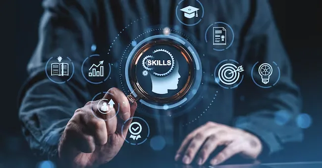 Person holding magnifying glass over digital icons symbolizing skills and learning, modern graphic style, dark blurred background, concept of professional development and education ImageFlow - stock.adobe.com